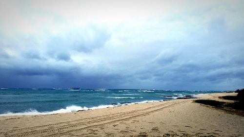 Scenic view of sea against cloudy sky