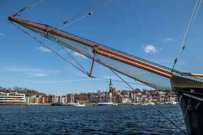 Cranes at commercial dock against sky
