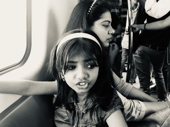 Mother and daughter traveling in metro, capturing the moment