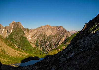 Scenic view of mountains against clear blue sky