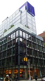 Low angle view of modern office building against sky