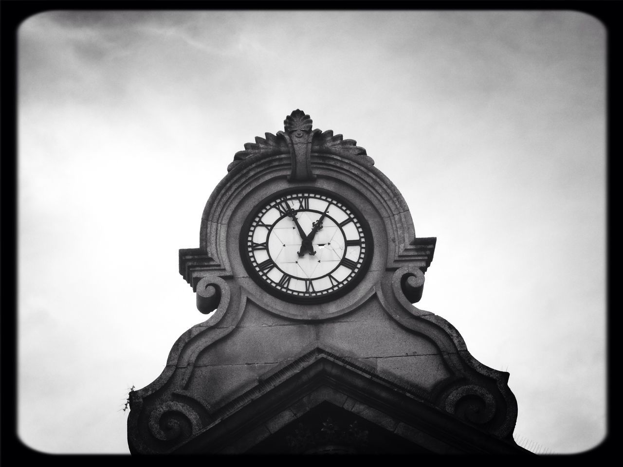 CLOSE-UP LOW ANGLE VIEW OF CLOCK AGAINST SKY