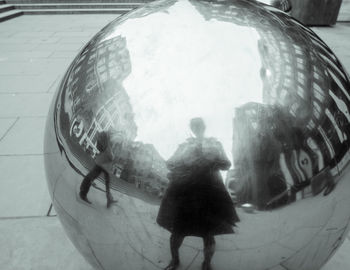 Reflection of people on glass in city