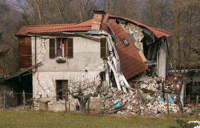 Abandoned house against buildings