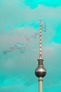 Communications tower against colored blue sky