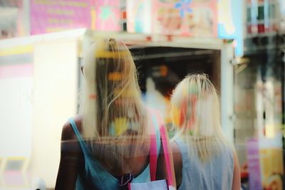 Rear view of people standing at night