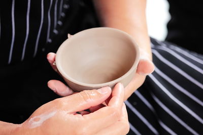 Close-up of hand holding coffee cup