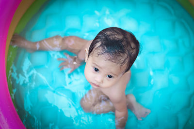 Directly above shot of cute baby girl in wading pool