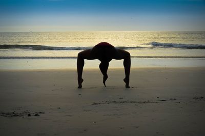 Full length of man on beach during sunset