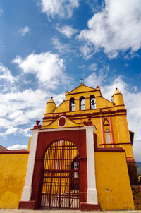 Low angle view of church against cloudy sky