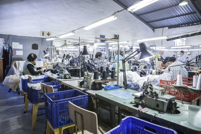 Seamstresses in factory sewing clothes
