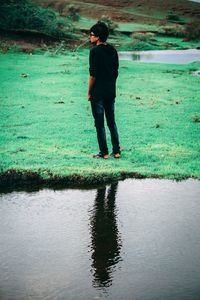 Rear view of man standing in water
