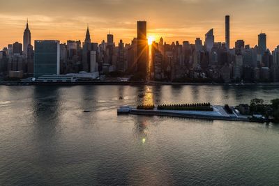 View of city at waterfront during sunset