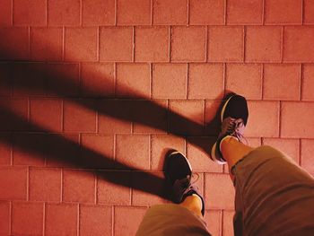 Low section of man standing on footpath