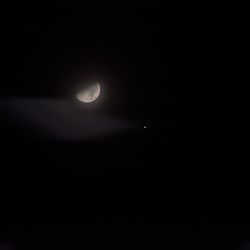 Low angle view of moon in sky at night