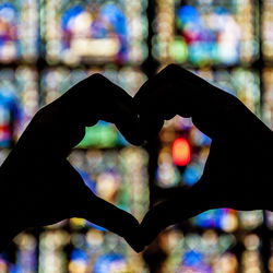 Close-up of hand holding heart shape leaf