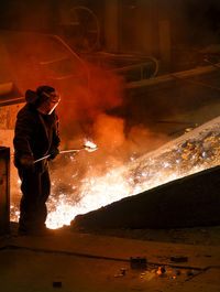 Side view of man working in factory