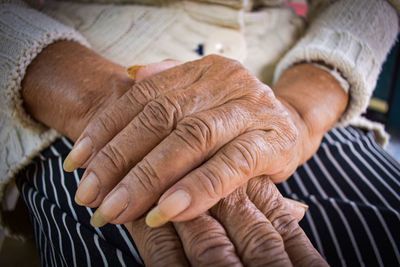 Midsection of senior woman sitting in home