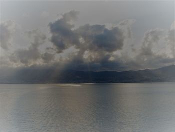 Scenic view of sea against storm clouds