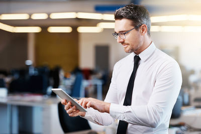 Businessman using mobile phone at office