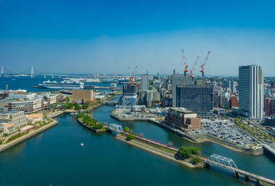 High angle view of buildings and harbor against sky