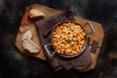 Directly above shot of pasta in container over cutting board