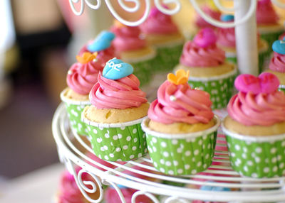 Close-up of multi colored cupcakes dessert tier