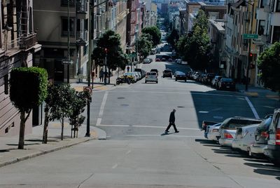 Man walking on road in city