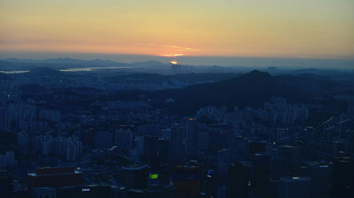 High angle view of buildings against sky during sunset