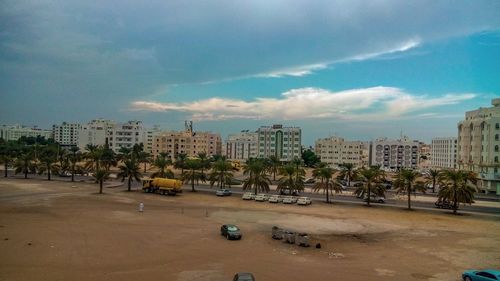 Buildings in city against cloudy sky