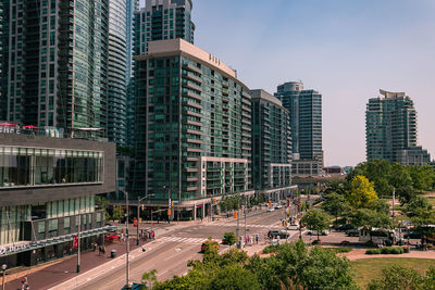 City street and buildings against sky