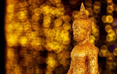 Close-up of gold colored buddha statue