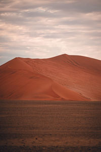 Scenic view of desert against sky during sunset