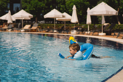 Boy swimming in pool