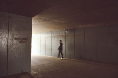 Man walking in illuminated corridor