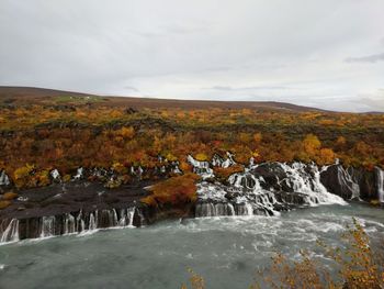 Scenic view of landscape and autumn against sky