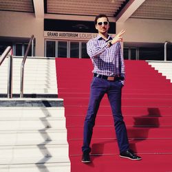 Portrait of man gesturing while standing on steps