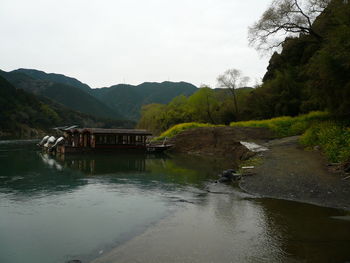 Scenic view of river in forest against sky