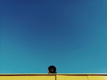 Low angle view of yellow against clear blue sky