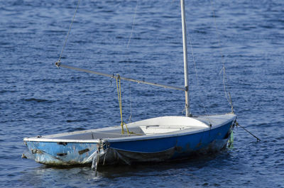 Blue and white fishing boat anchored at ribeira beach. salvador bahia brazil.