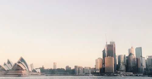 Buildings in city against clear sky