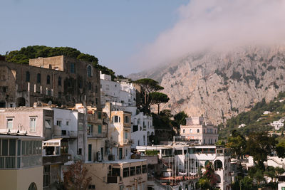 Buildings in town against sky