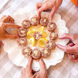 Cropped hand of woman holding food on table