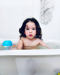 Portrait of shirtless boy in bathroom