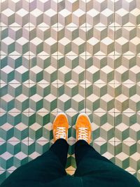 Low section of people standing on tiled floor