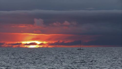 Scenic view of sea against dramatic sky