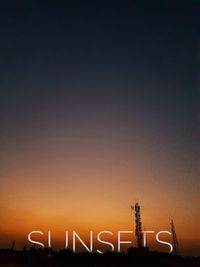 Silhouette communications tower against clear sky at sunset