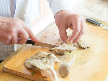 Midsection of man preparing food at table
