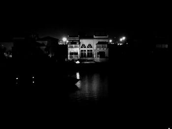 Illuminated buildings with waterfront at night