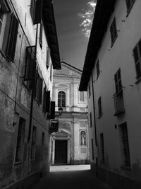 Low angle view of narrow alley along buildings